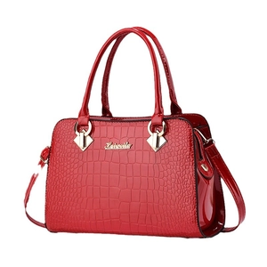 Elegant red crocodile pattern handbag with gold hardware and top handles on white background