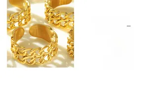 Detail of adjustable golden curb chain ring showing minimalist double-layer texture