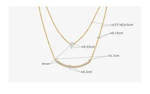 Close-up of double layer gold necklace with zircon pendant and curved micro-pave crystals