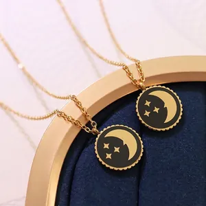 18K gold plated celestial necklace with moon and stars pendant on blue velvet stand