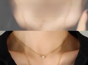 Detail of minimalist double-layered gold titanium necklace with sparkling zircon stone pendant