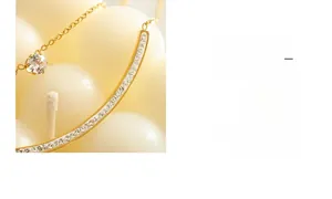 Macro detail of 18K gold plated necklace with double layered zircon stones and smile pendant