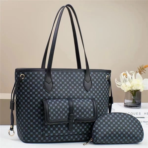 Detail of black and blue polka dot tote bag with matching pouch and snap pocket