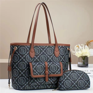 Detailed macro view of a three-piece luxury printed tote set with geometric logo texture