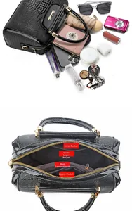 Detail view of the spacious black crocodile embossed bowling bag with interior compartments