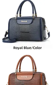 Detail showing royal blue and brown crocodile pattern handbags with gold metal logos