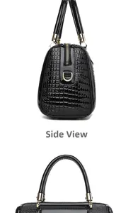Detailed side view of black crocodile pattern leather bag with shiny gold metal hardware