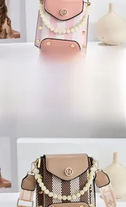 Detail of pink and brown checkered crossbody bags with pearl handle and wide strap