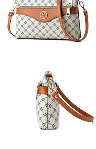 Detail view of printed floral canvas tote bag with brown leather trim and golden hardware