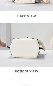 Detail of white leather bag featuring pearl handle and reinforced bottom with metal feet
