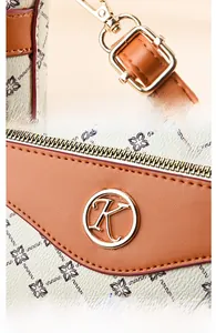 Detail of vintage floral tote with gold-plated metal hardware and brown leather strap