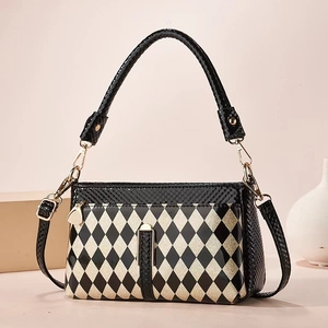 Elegant harlequin pattern shoulder bag in black and champagne lacquer finish