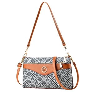 Vintage patterned tote bag with brown leather trim and circular metal logo detail