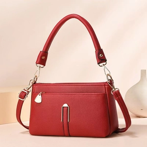 Chic red litchi texture underarm bag with golden hardware and adjustable strap