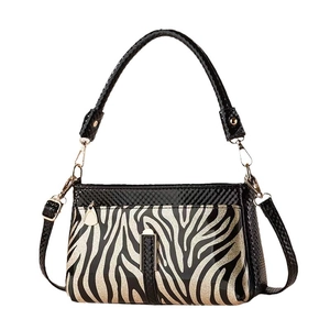 Elegant black patent leather crossbody bag with glitter zebra pattern and top handle