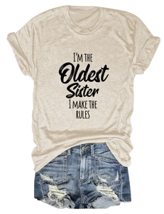 Ensemble t-shirt beige I'm The Oldest Sister et short en jean déchiré posés à plat