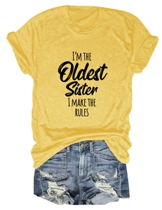 T-shirt jaune avec texte I'M THE OLDEST SISTER et short en jean à plat sur fond blanc