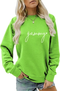Detail of neon green sweatshirt with gammy lettering and ribbed cuffs and hem