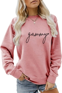 Close-up of pink long-sleeve sweatshirt showing the black gammy cursive print detail