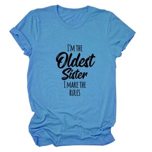 Détail d'un t-shirt bleu en coton avec inscription graphique noire I'M THE OLDEST SISTER