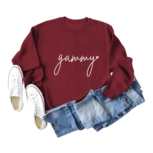 Flat lay of burgundy gammy sweatshirt with light blue jeans and white canvas shoes