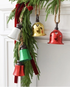 Detailed view of metal Christmas bells with heart cutouts and rustic hemp rope hangers