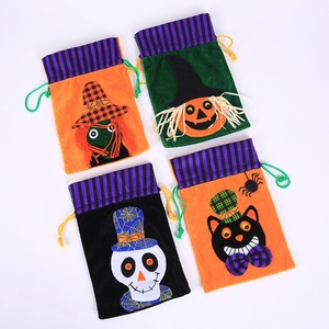 Four Halloween velvet drawstring bags with pumpkin, witch, skull and cat designs