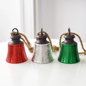Three-piece set of textured metal Christmas bells in red, silver, and green with hemp ropes