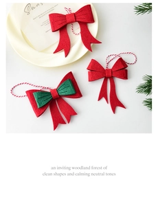 Close-up of red and green felt Christmas bow ornaments with braided hanging strings