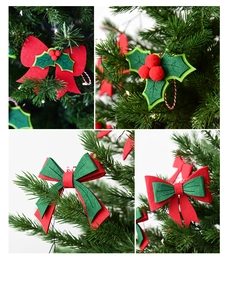 Detail of Christmas felt bow and holly berry hanging ornaments on pine tree branches