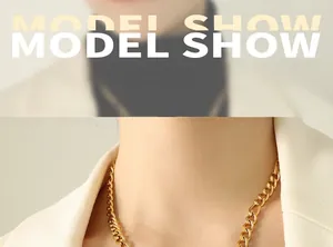 Close-up of 18k gold plated chunky curb chain necklace worn with a white blazer