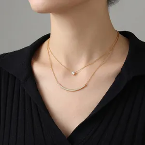 Double-layered gold necklace for women featuring a round zircon and curved bar pendant
