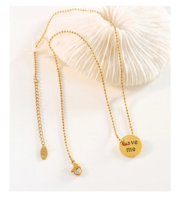 Detailed macro of golden bead chain with Love me pendant and K18 lobster clasp closure