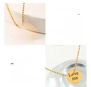 Detailed macro view of 18K gold plated circle pendant featuring Love me engraving