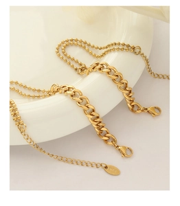 Detailed macro view of 18k gold plated bead chain with K18 engraved tag and lobster clasp