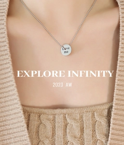 Detailed view of silver bead chain necklace with polished round Love Me engraved pendant