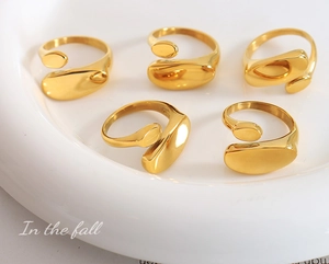 Set of five polished 18k gold plated stainless steel open rings with organic pebble shape