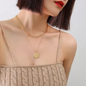 Elegant gold double-layered necklace featuring angel coin pendant and paperclip chain