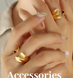 Close-up of dual irregular wave liquid gold rings on model fingers