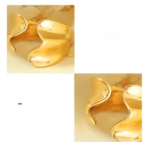 Macro shot of irregular streamlined 18K gold plated titanium steel open ring texture