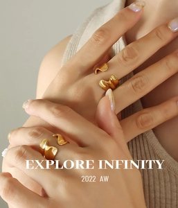 Close-up of irregular wave gold open rings with high-gloss finish on a model hand