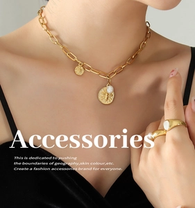 Detailed view of paperclip chain necklace with bee pendant and pearl ring on model