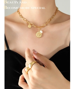 Detail of bee coin pendant with freshwater pearl on chunky gold chain necklace