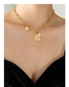 Close-up of gold chunky chain necklace with bee coin pendant and white freshwater pearl