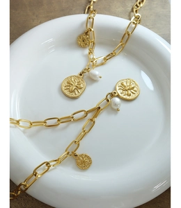 Detail of gold chain necklace with bee coin pendants and white freshwater pearls