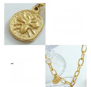 Detailed close-up of 18K gold plated titanium necklace with beetle relief pendant