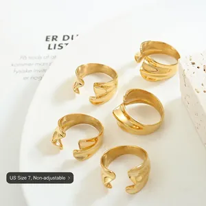Minimalist 18K gold plated wavy open rings set displayed on a white ceramic tray