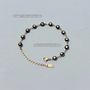 Bracciale Evil Eye in oro con perle smaltate nere e marchio K18 su catena 15+5cm