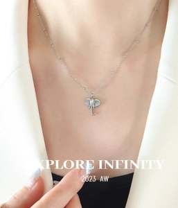Close-up of 3D elephant pendant necklace in silver titanium steel on a model