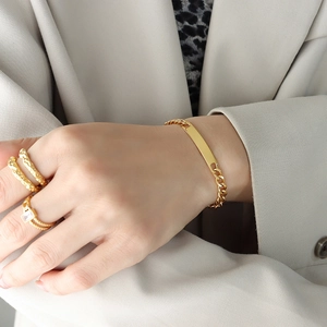Gold plated hip hop jewelry set with geometric bar bracelet and textured rings on model